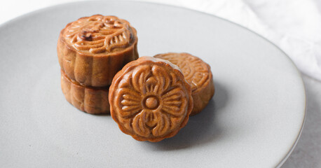 Overhead view of homemade mooncakes on a grey plate, top view of baked mooncakes, mooncakes for Lunar New Year and mid autumn festival