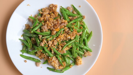 fried green bean with pork on white plate, thai and chinese food
