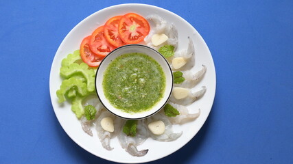 shrimp in fish sauce with Thai spicy seafood dipping sauce on white plate