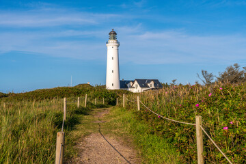 The picturesque Hirtshals Fyr lighthouse rises on a cliff in northern Jutland, Denmark, serving as...