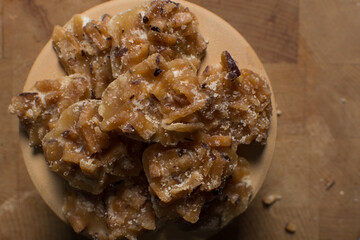 Overhead view of nigerian coconut candy, top view of candied coconuts discs, flatlay of bukayo candy or coconut drops