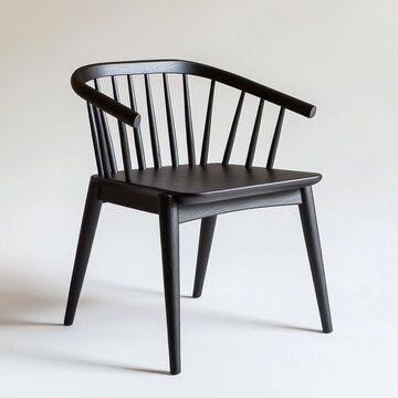 Black spindle back armchair on white background.
