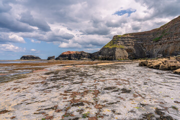Low tide on the North Sea coast at the East Cliffs in Whitby, England, UK