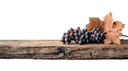 A cluster of ripe black grapes paired with a dried leaf rests on a rustic wooden surface, showcasing a rustic charm perfect for food-related themes.