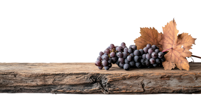 A cluster of ripe black grapes paired with a dried leaf rests on a rustic wooden surface, showcasing a rustic charm perfect for food-related themes.