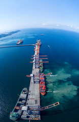 Tug boat pulling Cargo container ship go to international yard port. technology freight shipping...