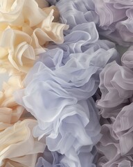 Fototapeta premium A close-up of soft, ruffled fabrics in pastel colors, showcasing delicate textures and layers.