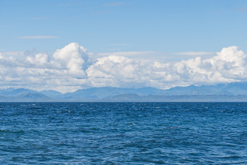 panorama view from the shore of Malcolm Island beautiful water of the ocean with clouds on blue sky