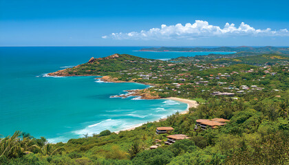 Fototapeta premium Stunning aerial view of a tropical coastline, showcasing turquoise waters, a pristine beach, lush greenery, and hillside homes under a vibrant blue sky.