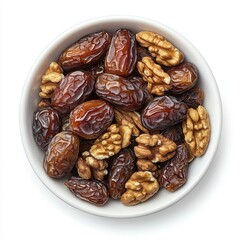Obraz premium Overhead View of Bowl of Dried Dates and Walnuts on White Background