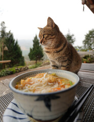 Sitting and thinking next to a bowl of noodles