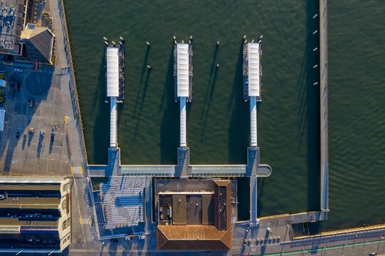 Aerial view of San Francisco, ferry docks, city buildings, and parking lots. Urban waterfront infrastructure. Embarcadero, San Francisco, California, USA - Powered by Adobe