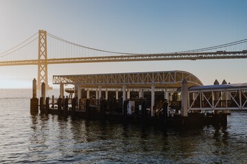 San Francisco Ferry terminal at sunrise, with the Bay Bridge in the background. Tranquil morning scene. Embarcadero, San Francisco, California, USA