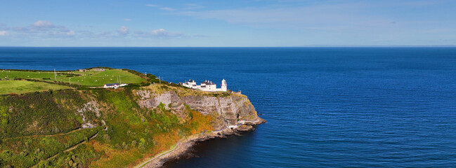 Panoramic Aerial view of Blackhead Lighthouse on the beautiful and spectacular coastline of the Glens of Antrim Northern Ireland