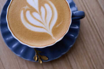 Sipping Tranquility. A crafted latte with latte art and cappucinno on wooden table. Top view