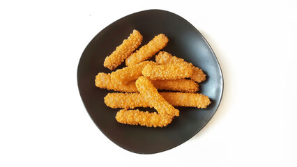 Nuggets. Crispy chicken nuggets with bubble crumbs in black plate, isolated on white background