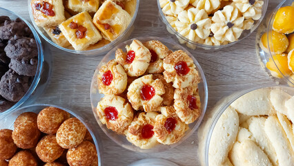 A set of delicious cookies, chocolate chip cookies, thumbprint cookies, flower cookies, pineapple tarts, for eid celebration, Isolated from white background from top view. happy eid al fitr