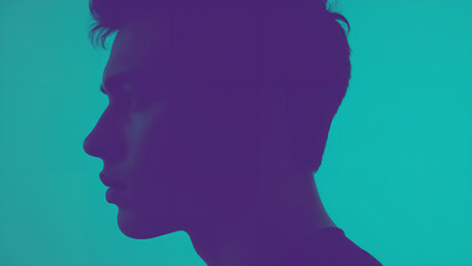Obraz premium Silhouette of a Man's Profile Against a Teal Background
