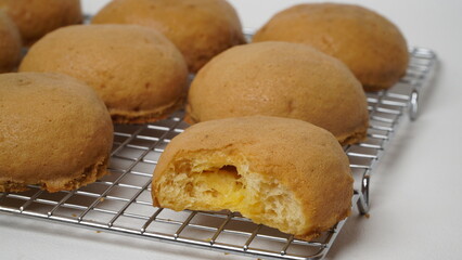 Coffee milk buns are served using a cooling rack that is placed on a white background (isolated white).