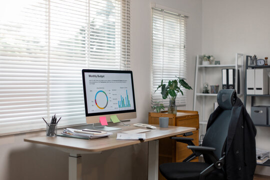 desk, screen, desktop, monitor, No people shot of modern computer monitor with graphs on screen on desk in office interior, copy space