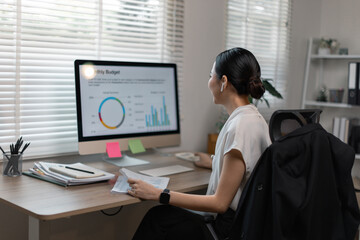 Young business finance market analyst in eyeglasses working at office  .Business woman analyze...