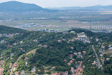 Aerial view of Brasov surrounded by the Carpathian mountains dotted with ski resorts including the ever popular Boiana Brasov. Romania, the Balkans, Eastern Europe