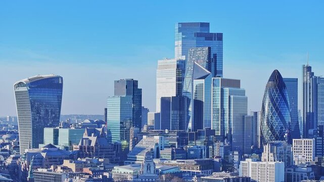 Aerial drone shot of the business district London skyline with The Gherkin, Walkie Talkie and The Sky Garden by the River Thames, London, United Kingdom.
