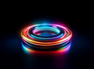 A luminous ring with vibrant rainbow colors glows brightly against a dark backdrop. The circular shape radiates light, creating a modern and futuristic effect.