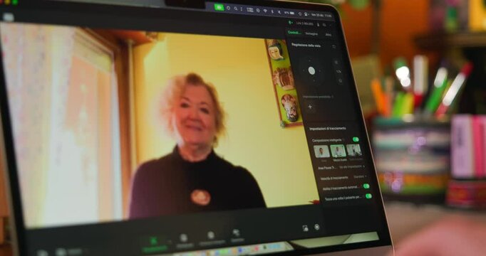 Woman Recording Video On iPad Tablet With Insta360 Link 2 Webcam. closeup shot