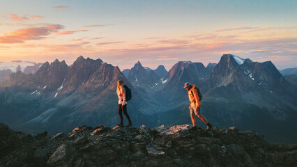 Epic travel - active couple friends hiking in Norway man and woman climbing mountains adventure vacation healthy lifestyle outdoor - family tourist exploring Lyngen Alps endurance sport activity trip