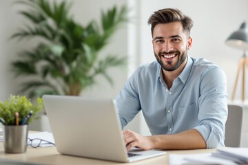 Smiling young man in blue shirt using laptop at desk with office supplies, green plant, and lamp in bright background. Concept of productivity and success. Ai generative