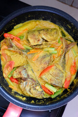 Pesmol fish or ikan pesmol with yellow curry.