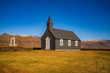 Fototapeta premium The Búðakirkja Church is a small wooden church erected on the southern shore of the Snæfellsnes Peninsula in Iceland.