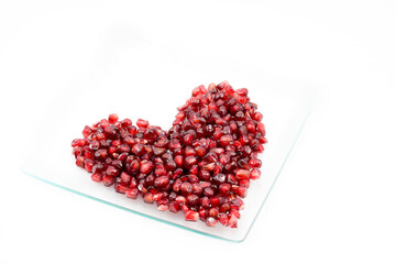 Pomegranate and red heart, Valentine's Day, black background.
