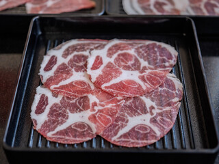 Sliced belly pork for shabu or Japanese hot pot on black tray
