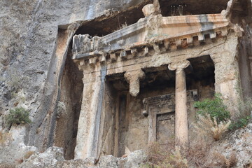 Fototapeta premium View of the Tomb of Amyntas in Fethiye, Mugla, Turkey. The Lycian Rock Tombs at ancient Telmessos currently in Fethiye is a popular tourist attraction in Turkey.