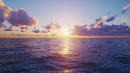Ocean Sunset Tranquil water reflects golden sunlight under puffy clouds