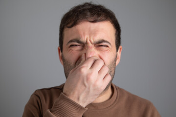 Fototapeta premium Caucasian man disgusted expression for stink.