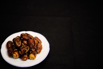 Premium Dates on White Plate: Elegant Middle Eastern Superfood