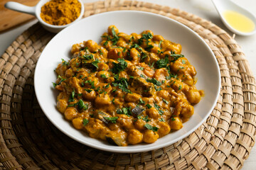 Chickpea curry with eggplant, a traditional Indian vegan recipe.
