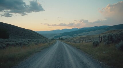 Dirt road stretches into the distance through rolling hills