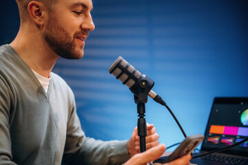 Man with microphone in the studio, conception of podcast