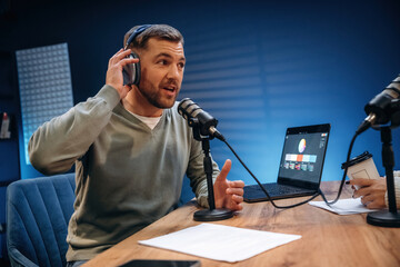 Morning radio. Man with microphone in the studio, conception of podcast