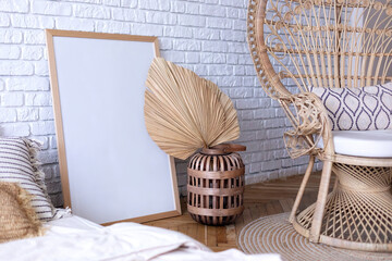 Rattan peacock chair in room with boho decor. Cozy modern stylish interior design bedroom with...