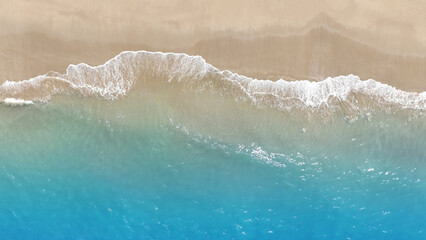 Tropical Beach with the soft wave water of the sea on the sandy beach background as texture with splashes