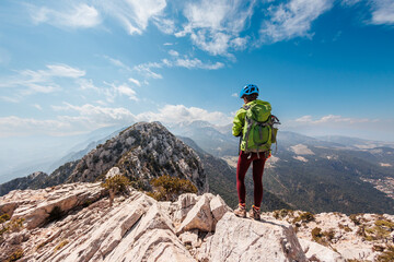 adventure in the mountains.  girl with a backpack in the high mountains. Rock climbing and...