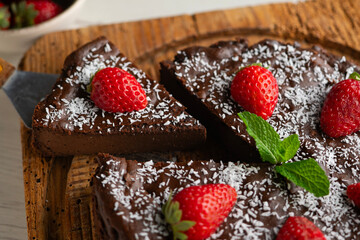 Delicious sweet cheesecake with chocolate and fresh strawberries.