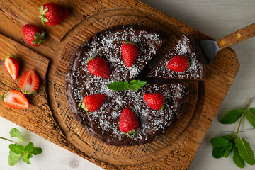 Delicious sweet cheesecake with chocolate and fresh strawberries.