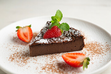 Delicious sweet cheesecake with chocolate and fresh strawberries.