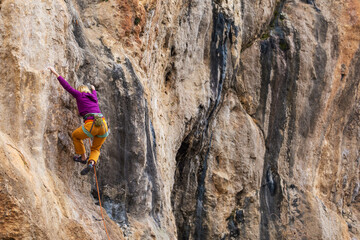A girl trains strength and endurance on rocks